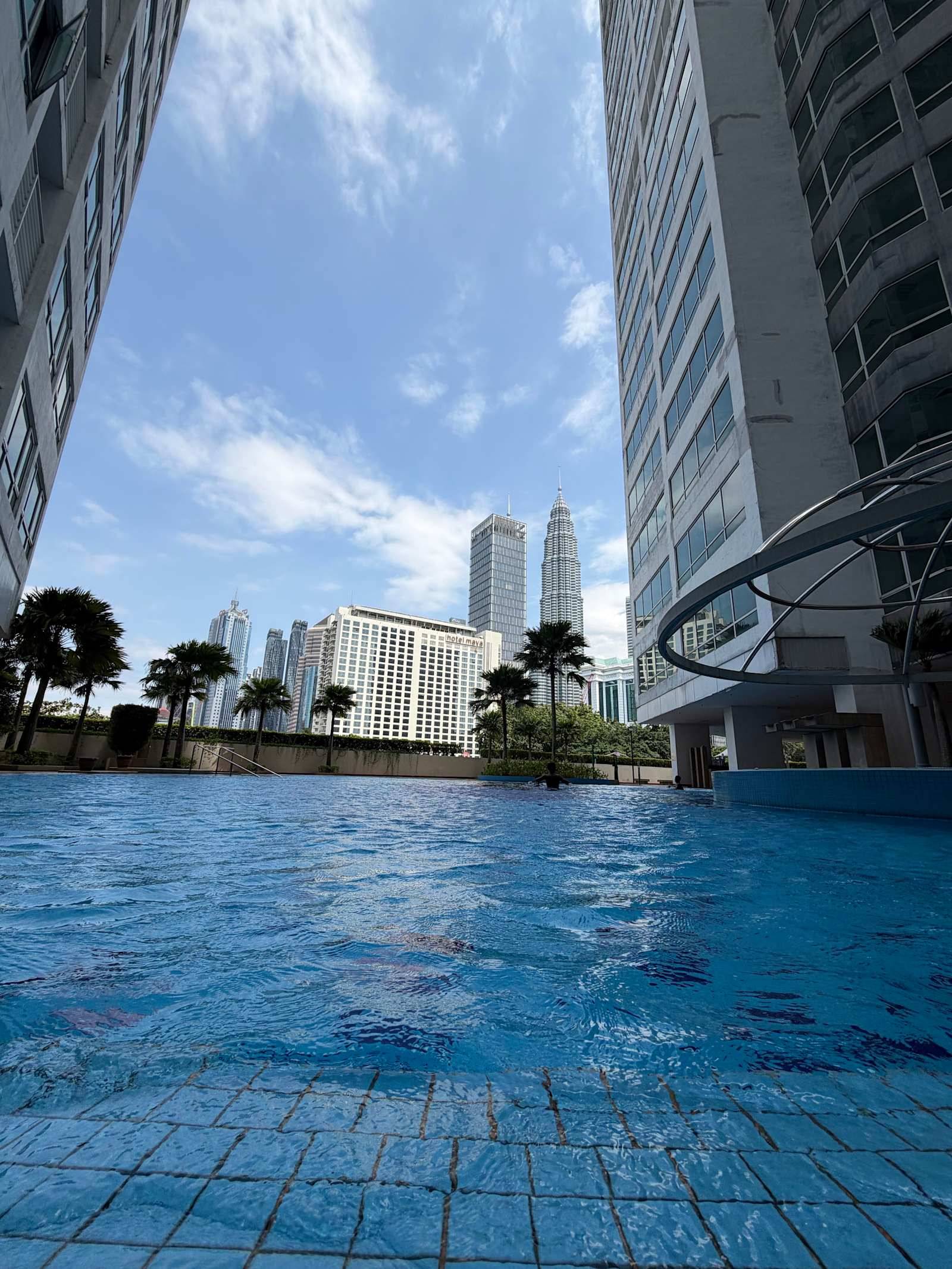 Hostel with pool in Kuala Lumpur — Crest Residence pool facing Petronas Towers