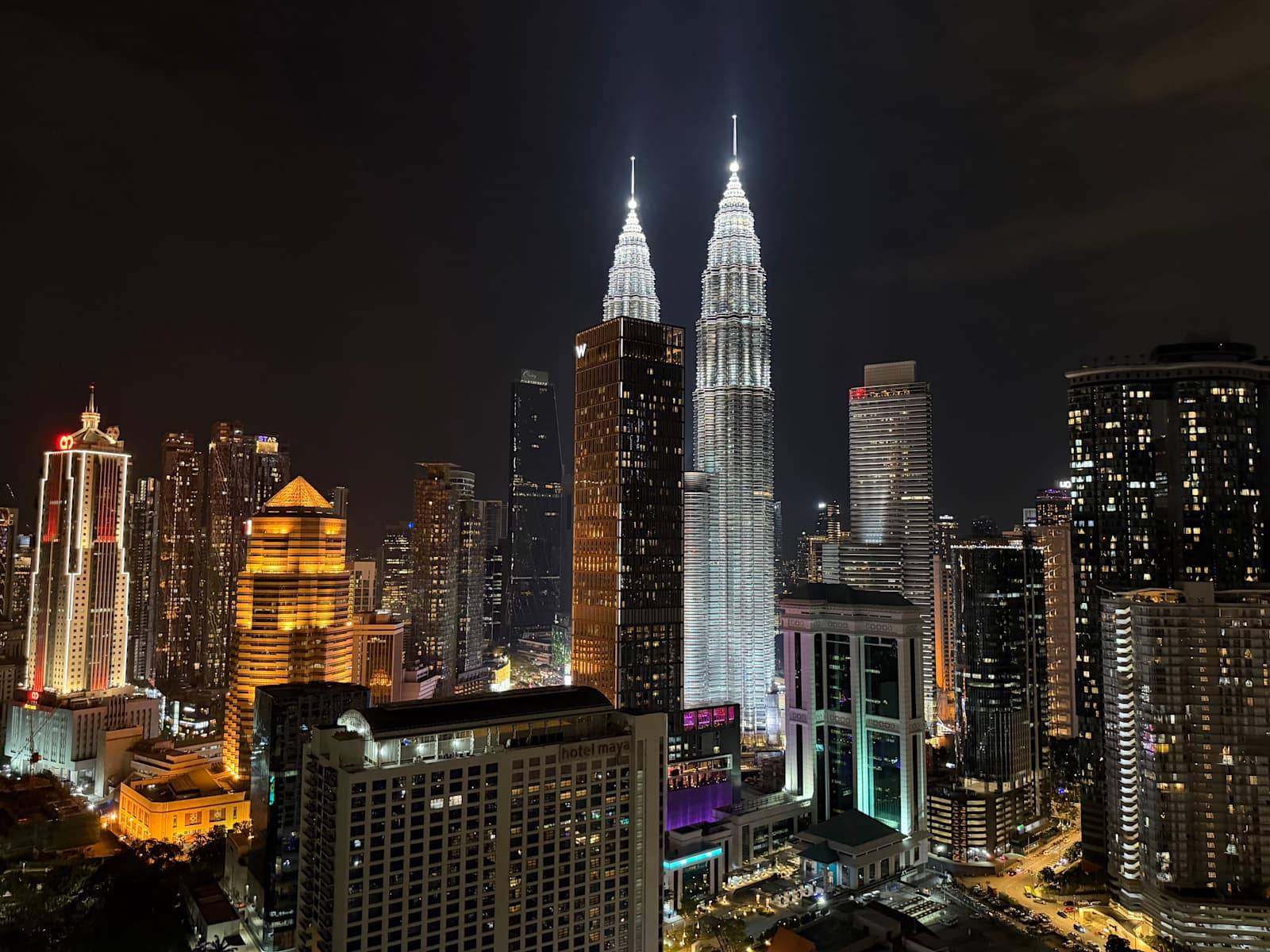 Night panorama of Petronas Twin Towers from Poshpack Skyline Hostel
