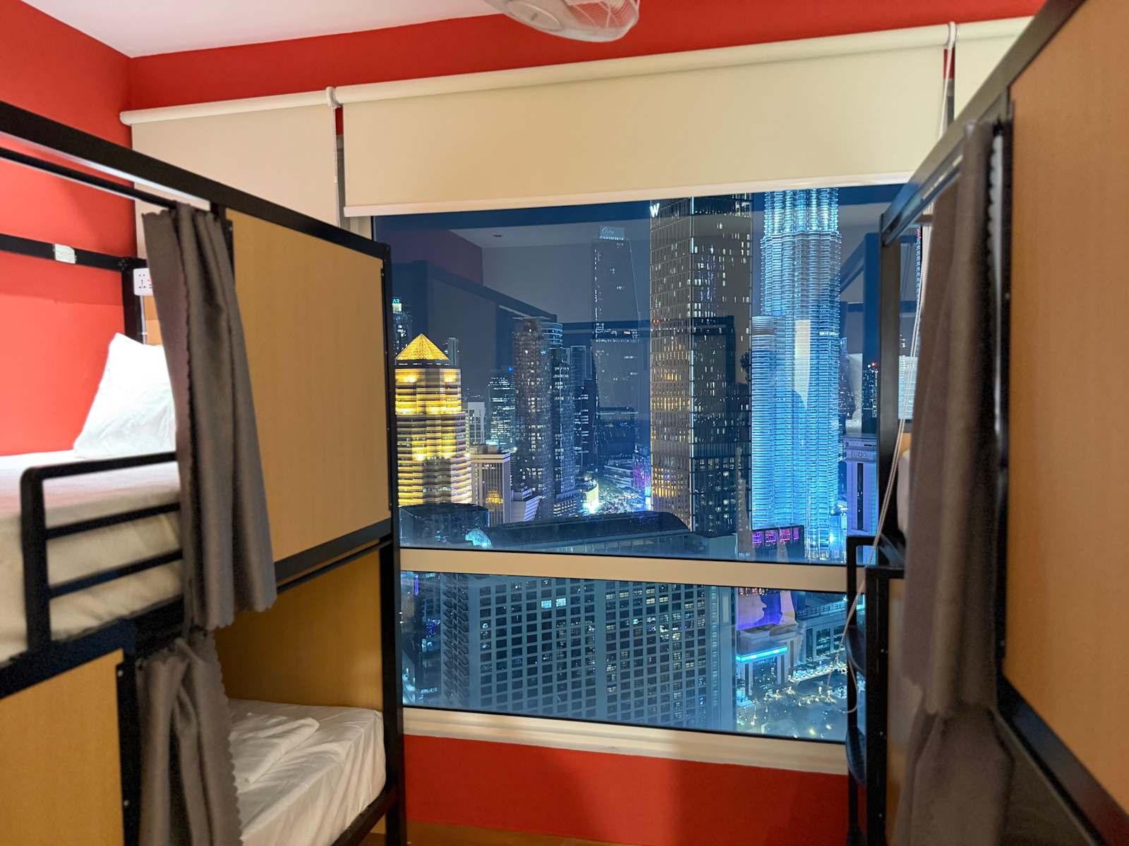 Skyline dorm bunk beds with city lights at Poshpack Skyline Hostel Kuala Lumpur