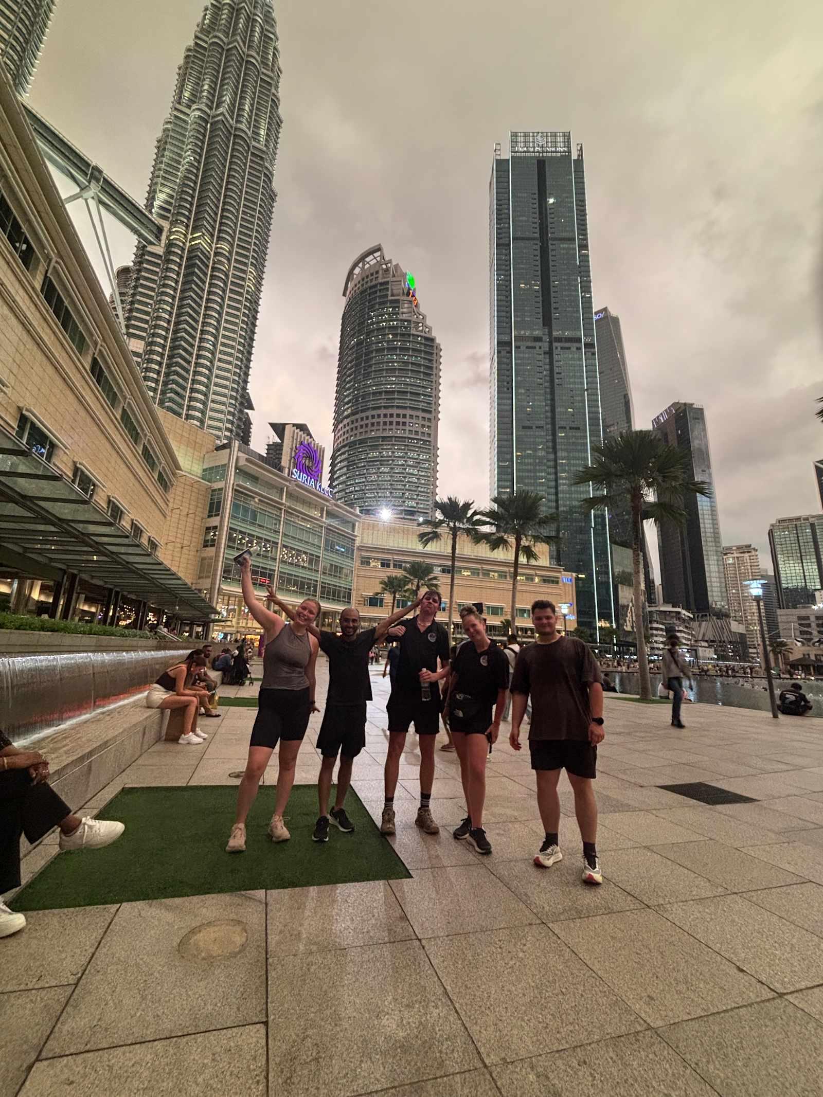 Travelers at KLCC by the Petronas Twin Towers near the hostel