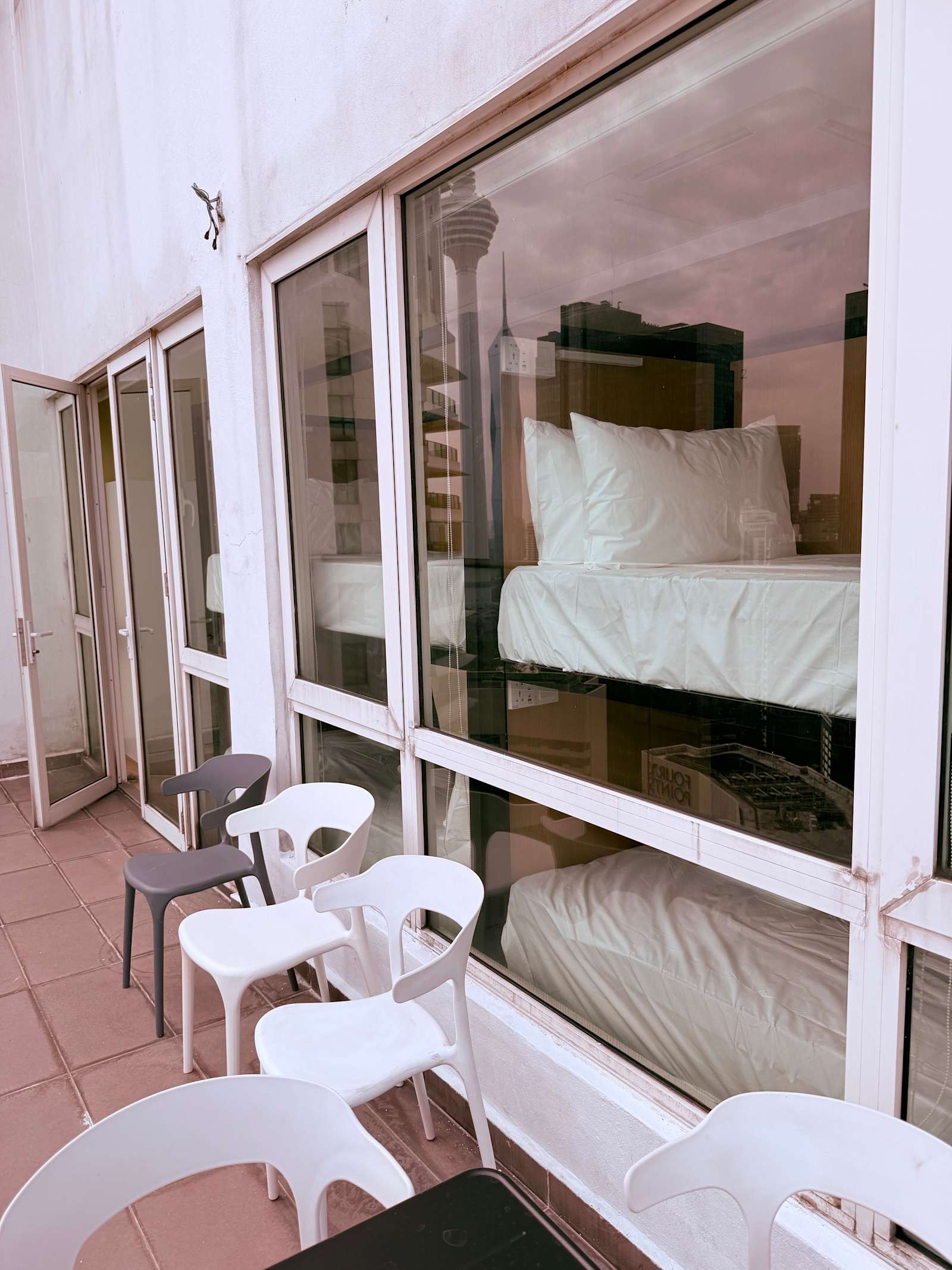 Balcony with chairs outside the rooms